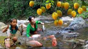 Mother with daughter pick eggfruit and catch many fish by waterfall - Roasted fish chili for lunch