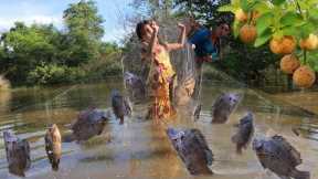 Mother with daughter net fishing in flood forest- Fresh fish soup so delicious for delicious