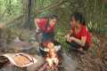 Two sisters catch fish in river and